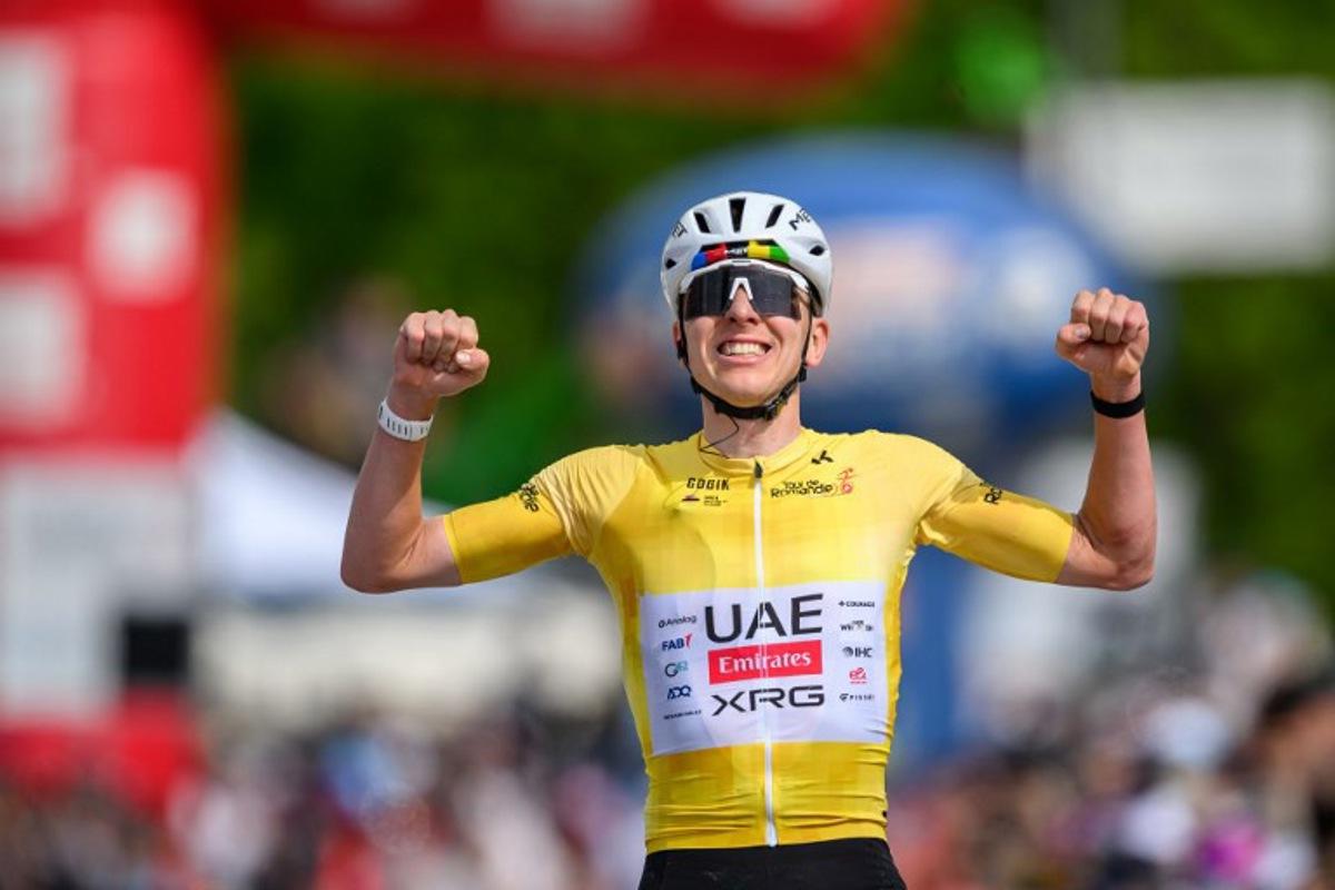 UAE Team Emirates-XRG's Slovenian rider Tadej Pogacar celebrates as he crosses the finish line wining the fourth stage of the Tour of Romandie UCI cycling World tour, 149.6 km from Broc and to Charmey, in Charmey, Switzerland, on May, 2, 2026. Fabrice COFFRINI / AFP