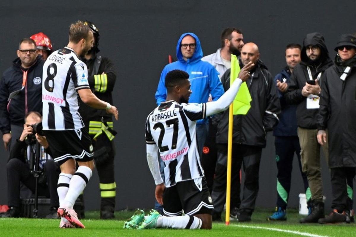 Udinese's Belgian defender #27 Christian Kabasele (R) celebrates with teammate Inter Milan's Austrian forward #08 Marko Arnautovic after scoring a goal during the Italian Serie A football match between Udinese and Inter Milan at the Bluenergy Friuli Stadium, in Udine on September 28, 2024. ANDREA PATTARO / AFP