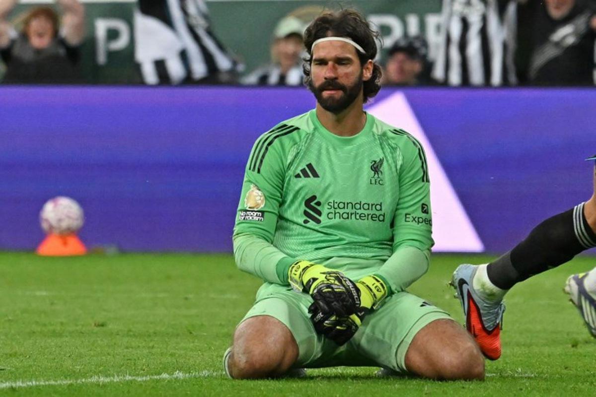 Liverpool's Brazilian goalkeeper #01 Alisson Becker reacts after conceding their second goal during the English Premier League football match between Newcastle United and Liverpool at St James' Park in Newcastle-upon-Tyne, north east England on August 25, 2025. ANDY BUCHANAN / AFP
