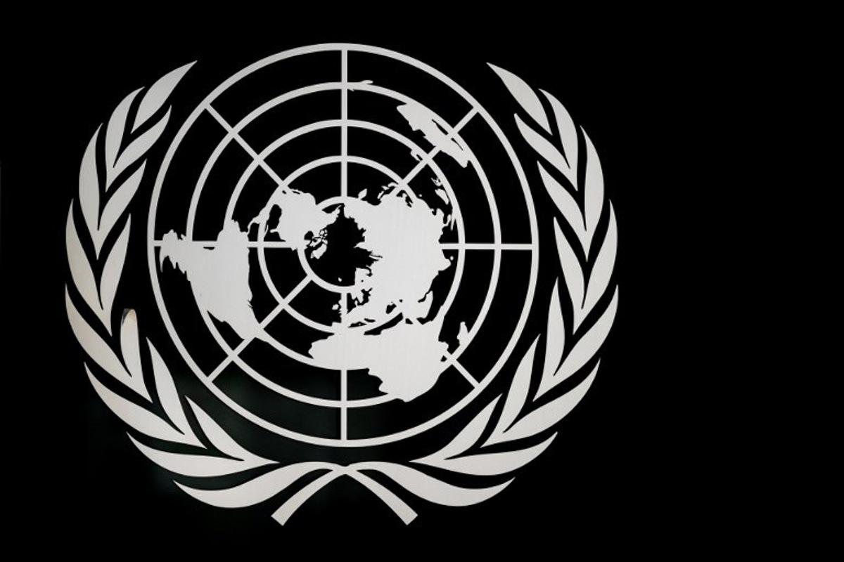 A sign of the United Nations is seen at the "Palais des Nations" building which houses the UN Offices in Geneva on March 3, 2026. Fabrice COFFRINI / AFP