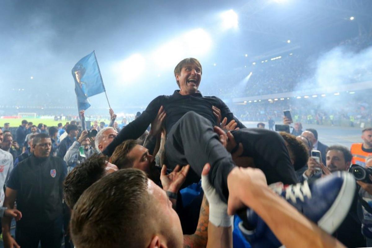 Napoli's Italian coach Antonio Conte is thrown in the air by his players as they celebrate after winning Italian Serie A football match between Napoli and Cagliari at the Diego Armando Maradona stadium in Naples on May 23, 2025. Carlo Hermann / AFP