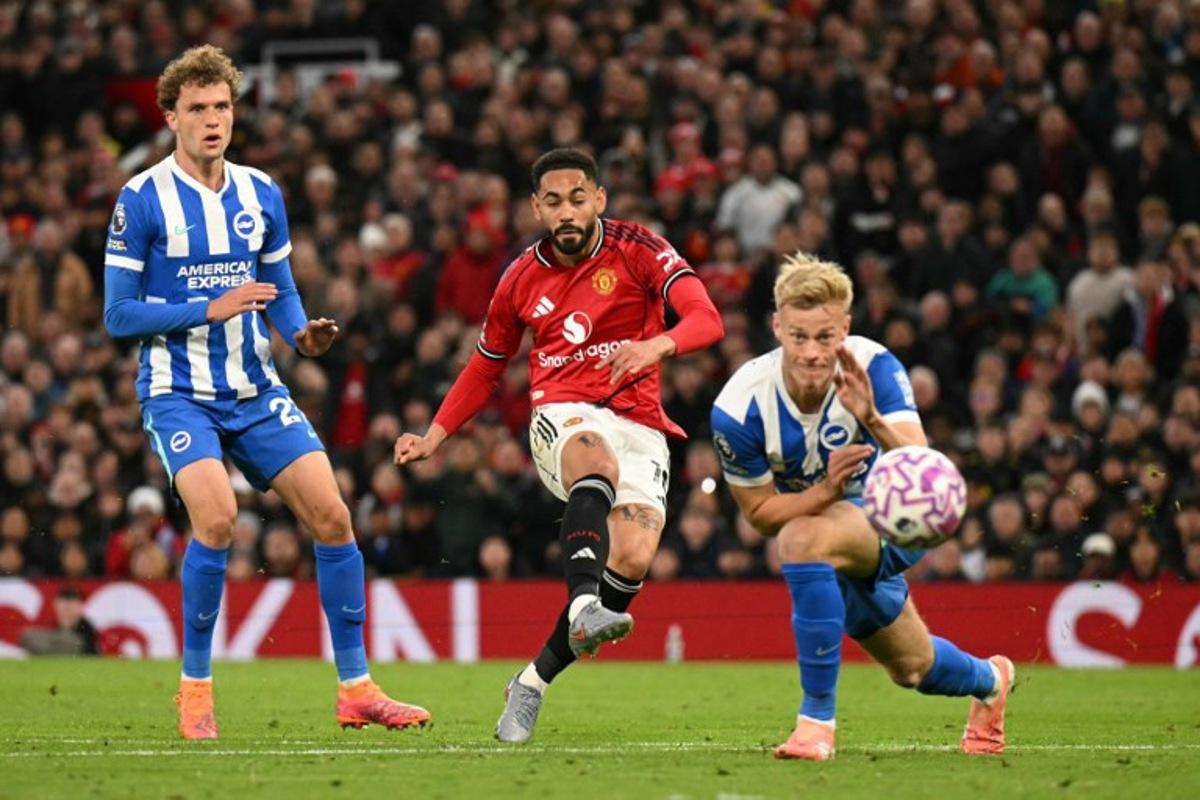 Manchester United's Brazilian striker #10 Matheus Cunha (C) shoots to score the opening goal for 1-0 during the English Premier League football match between Manchester United and Brighton and Hove Albion at Old Trafford in Manchester, north west England, on October 25, 2025. Oli SCARFF / AFP