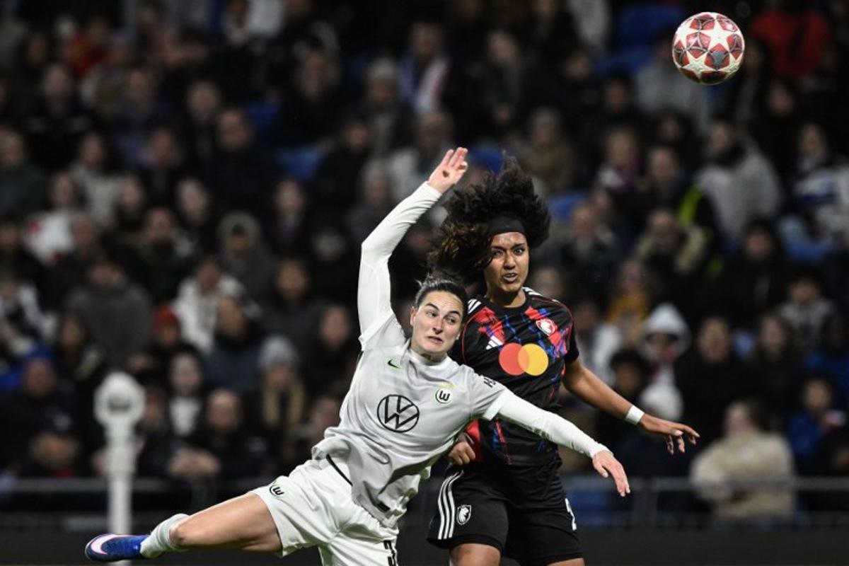 Lyon's US midfielder #20 Lily Yohannes (R) fights for the ball with VfL Wolfsburg's Dutch defender #03 Caitlin Dijkstra (L) during the UEFA Women's Champions League quarter final second leg football match between OL Lyonnes (Lyon) and VfL Wolfsburg at the Groupama stadium in Decines-Charpieu, central-eastern France, on April 2, 2026. JEFF PACHOUD / AFP