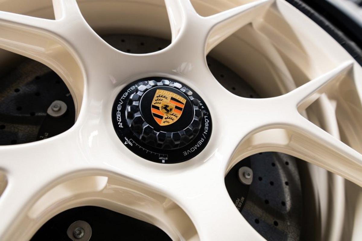 The Porsche emblem in the middle of a rim of a Porsche 911 S/T is pictured at the "Exclusive Manufaktur" of German luxury car maker Porsche, where clients can get their vehicles customized in Stuttgart - Zuffenhausen on March 6, 2025 SILAS STEIN / AFP