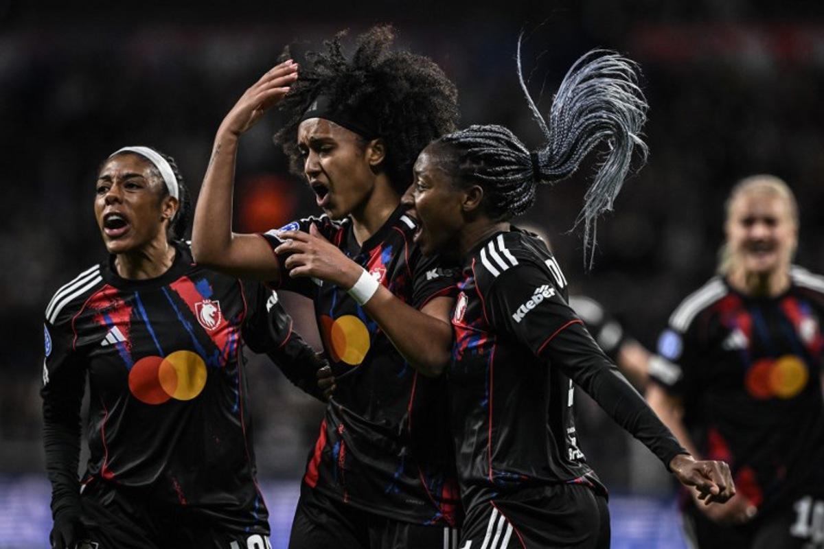 Lyon's US midfielder #20 Lily Yohannes (C) celebrates with teammates after scoring her team's first goal during the UEFA Women's Champions League quarter final second leg football match between OL Lyonnes (Lyon) and VfL Wolfsburg at the Groupama stadium in Decines-Charpieu, central-eastern France, on April 2, 2026. JEFF PACHOUD / AFP
