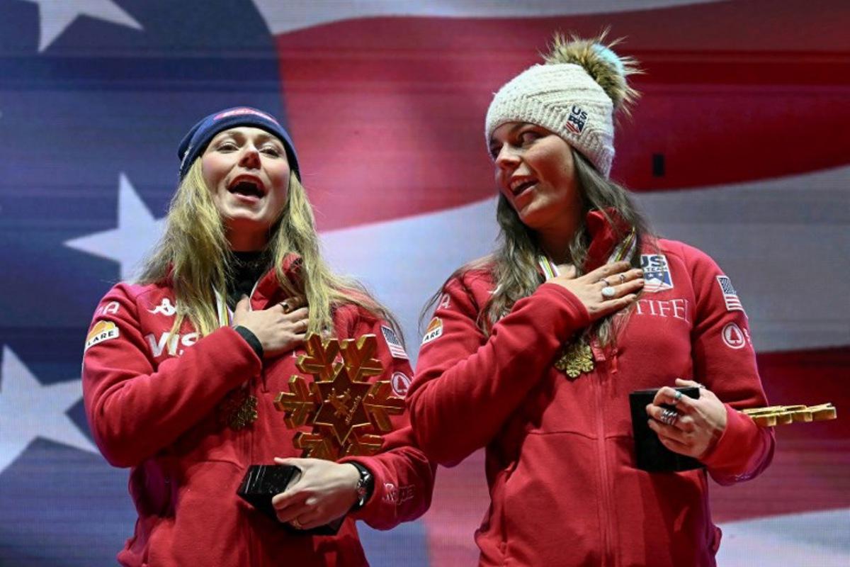 Winner US' Mikaela Shiffrin (L) and US' Breezy Johnson celebrate during the medal ceremony after the Women's Team Combined event of the Saalbach 2025 FIS Alpine World Ski Championships in Hinterglemm on February 11, 2025. Fabrice COFFRINI / AFP