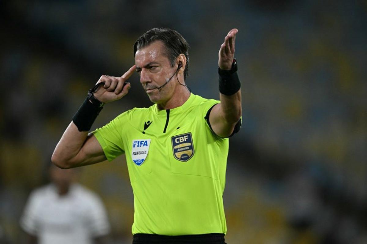 Brazilian referee Raphael Claus gestures during the Brasileirao Serie A football match between Vasco da Gama and Fluminense at the Maracana Stadium in Rio de Janeiro, Brazil, on March 18, 2026. MAURO PIMENTEL / AFP