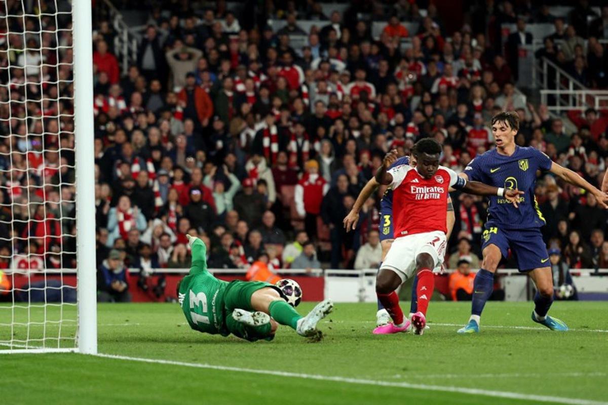 Arsenal's English midfielder #07 Bukayo Saka scores the team's first goal during the UEFA Champions League second-leg semi-final football match between Arsenal and Atletico Madrid at the Emirates Stadium in north London on May 5, 2026. Adrian Dennis / AFP