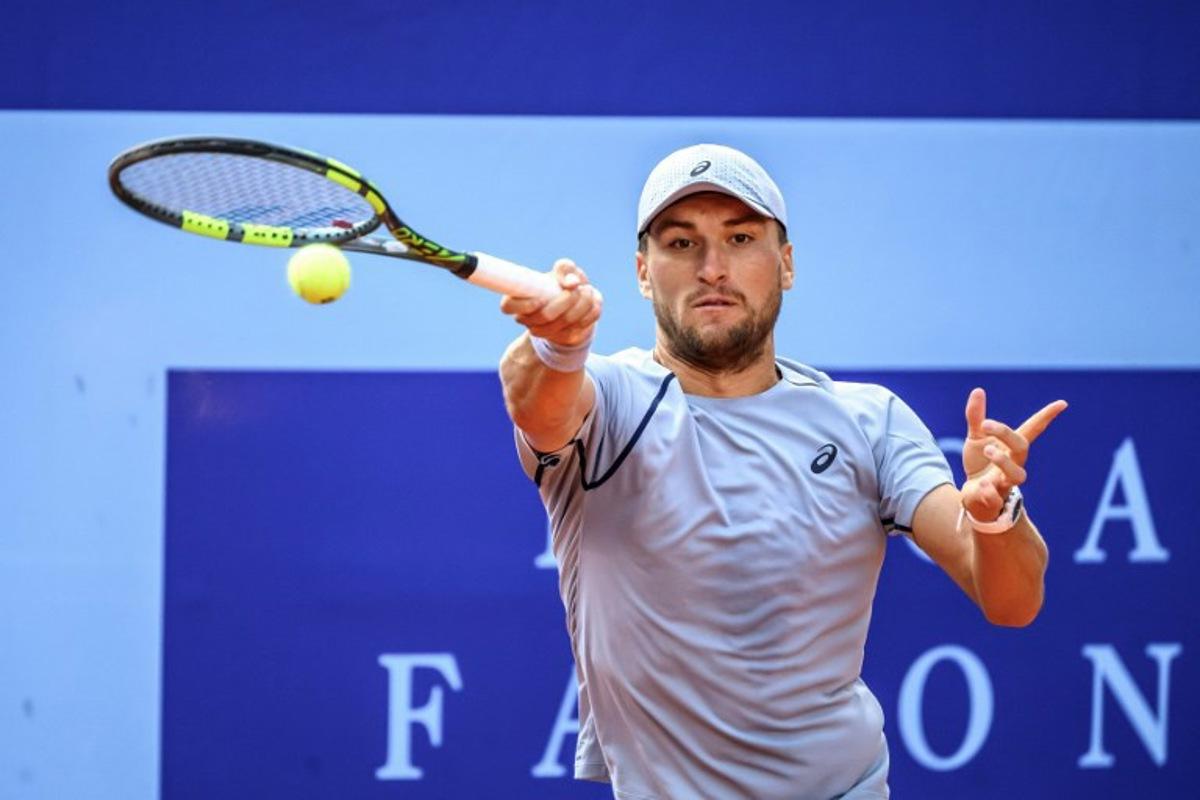 Belgium's Raphael Collignon returns the ball to Greece's Stefanos Tsitsipas during their men's singles final match at the Swiss Open tennis tournament in Gstaad, on July 19, 2026. Fabrice COFFRINI / AFP