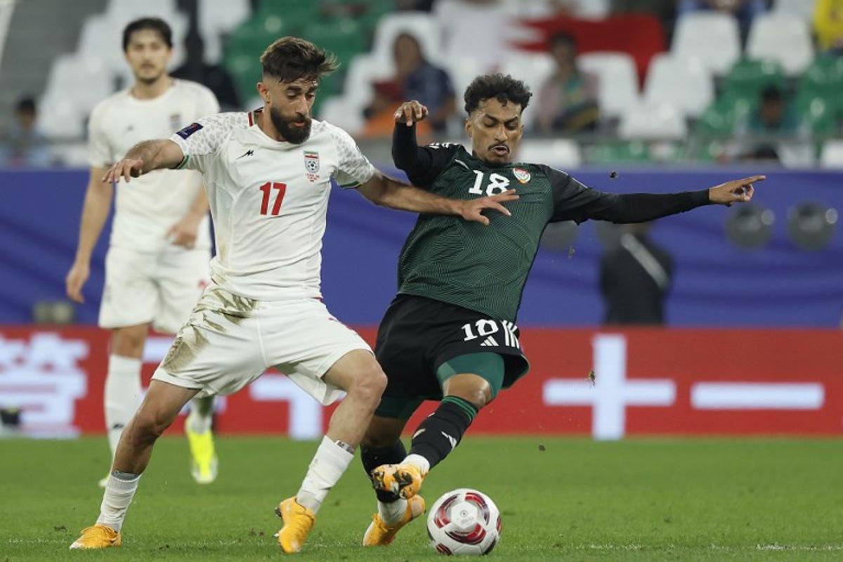 Iran's midfielder #17 Ali Gholizadeh vies for the ball against UAE's midfielder #18 Abdullah Ramadan during the Qatar 2023 AFC Asian Cup Group C football match between Iran and United Arab Emirates at Education City Stadium in al-Rayyan, west of Doha, on January 23, 2024. KARIM JAAFAR / AFP