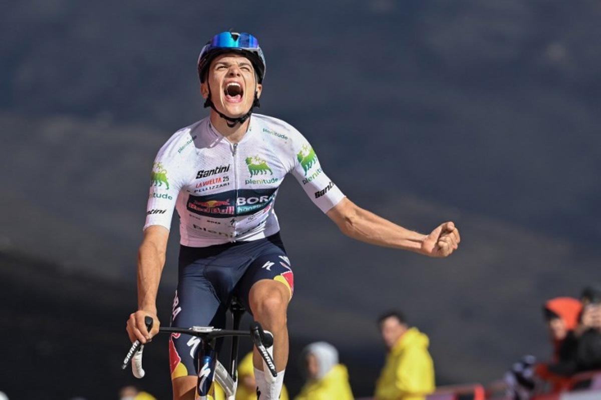 Team Bora's Italian rider Giulio Pellizzari celebrates as he crosses the finish line to win the 17th stage of the Vuelta a Espana, a 143 km race between O Barco de Valdeorras and Alto de El Morredero, Ponferrada, on September 10, 2025. Miguel RIOPA / AFP