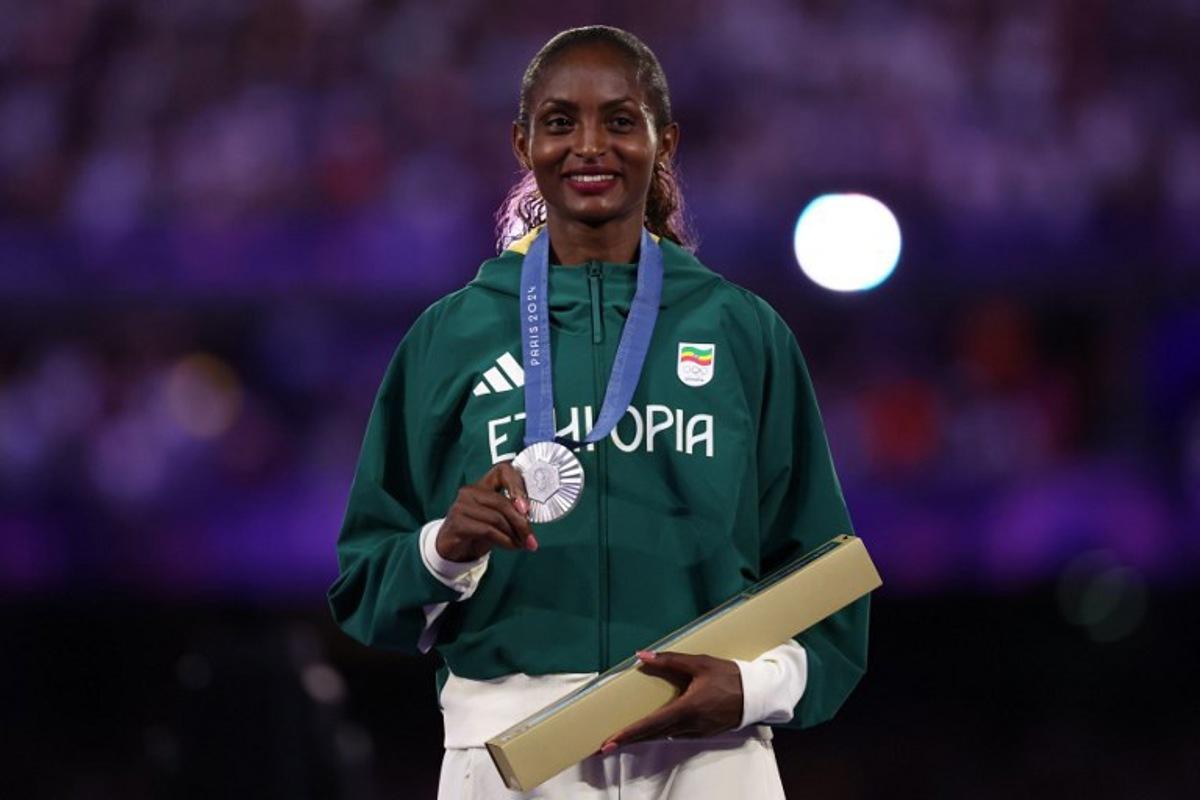 Silver medallist Ethiopia's Tigist Assefa poses during the podium ceremony for the women's marathon of the athletics event during the closing ceremony of the Paris 2024 Olympic Games at the Stade de France, in Saint-Denis, in the outskirts of Paris, on August 11, 2024. Franck FIFE / AFP