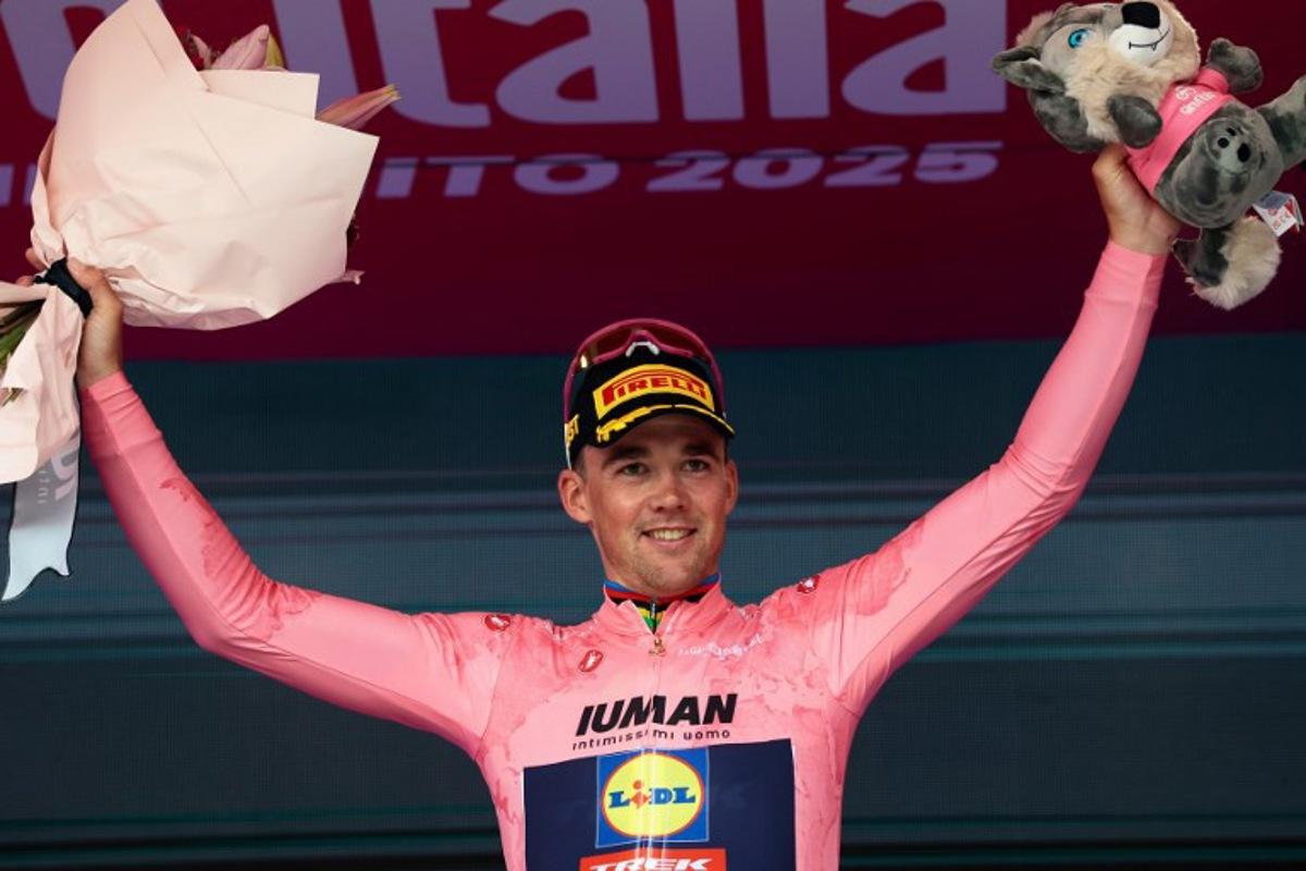 Stage winner Lidl-Trek's Danish rider Mads Pedersen wearing the overall leader's pink jersey (Maglia Rosa) celebrates on the podium after the 3rd stage of the 108th Giro d'Italia cycling race, 160km from Vlore to Vlore in Albania, on May 11, 2025. Luca Bettini / AFP