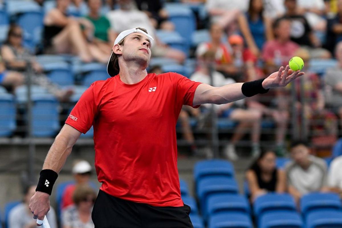 Belgium's Zizou Bergs serves to Canada's Cleeve Harper and Victoria Mboko during their mixed doubles match at the United Cup tennis tournament on Ken Rosewall Arena, Sydney on January 6, 2026. Izhar KHAN / AFP