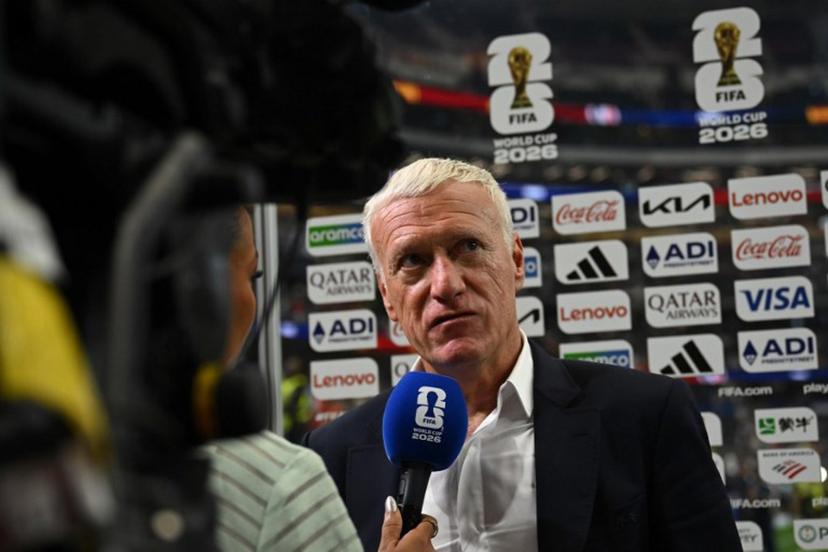 France's head coach Didier Deschamps speaks with a sports broadcaster after his team lost the 2026 World Cup football tournament semi-final match between France and Spain at the Dallas Stadium in Arlington on July 14, 2026. Paul ELLIS / AFP
