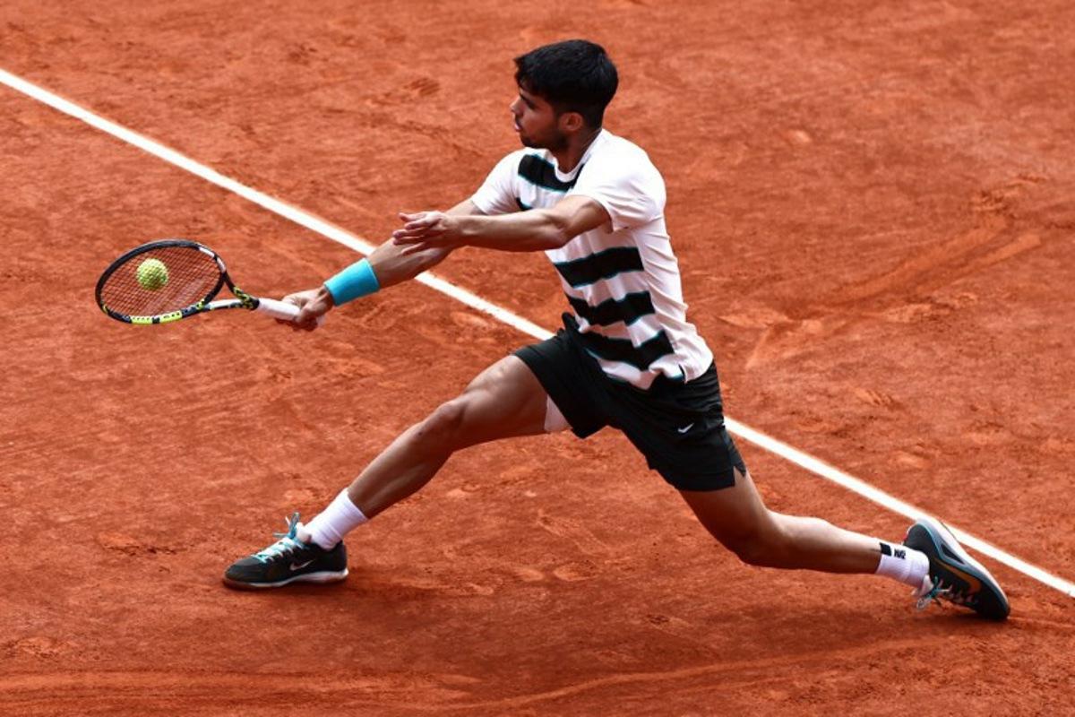 Spain's Carlos Alcaraz plays a backhand return to Italy's Jannik Sinner during their men's singles final match on day 15 of the French Open tennis tournament on Court Philippe-Chatrier at the Roland-Garros Complex in Paris on June 8, 2025. Thibaud MORITZ / AFP