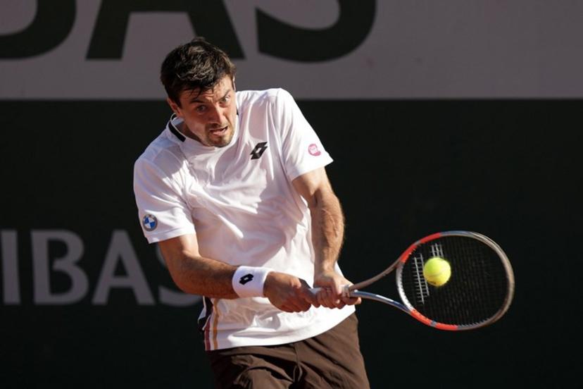 Austria's Sebastian Ofner plays a backhand return to Italy's Luciano Darderi during their men's singles match on day 3 of the French Open tennis tournament at the Roland-Garros Complex in Paris on May 26, 2026. Dimitar DILKOFF / AFP