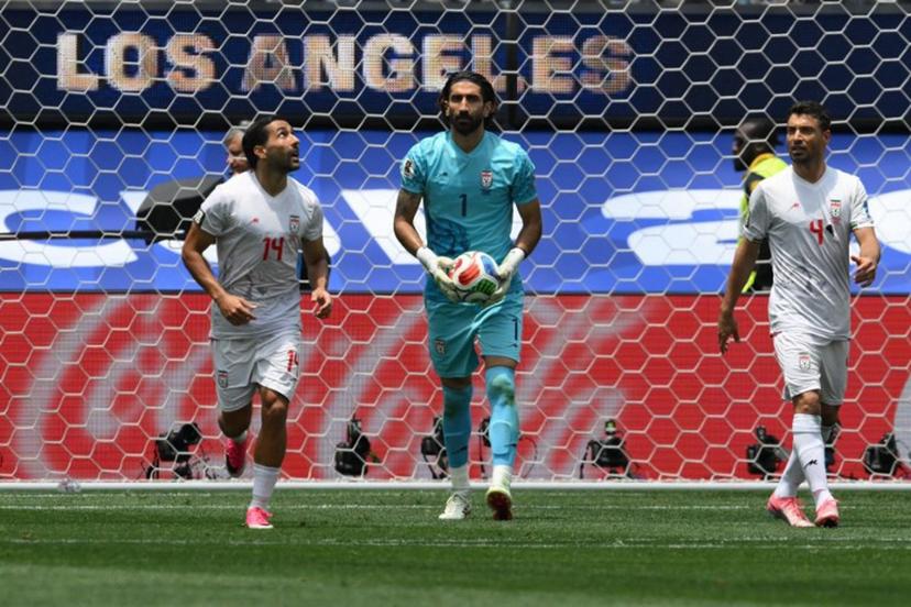 Iran's goalkeeper #01 Alireza Beiranvand holds the ball next to teammates midfielder #14 Saman Ghoddos and defender #04 Shojae Khalilzadeh during the 2026 World Cup Group G football match between Belgium and Iran at the Los Angeles Stadium in Inglewood on June 21, 2026. Patrick T. Fallon / AFP