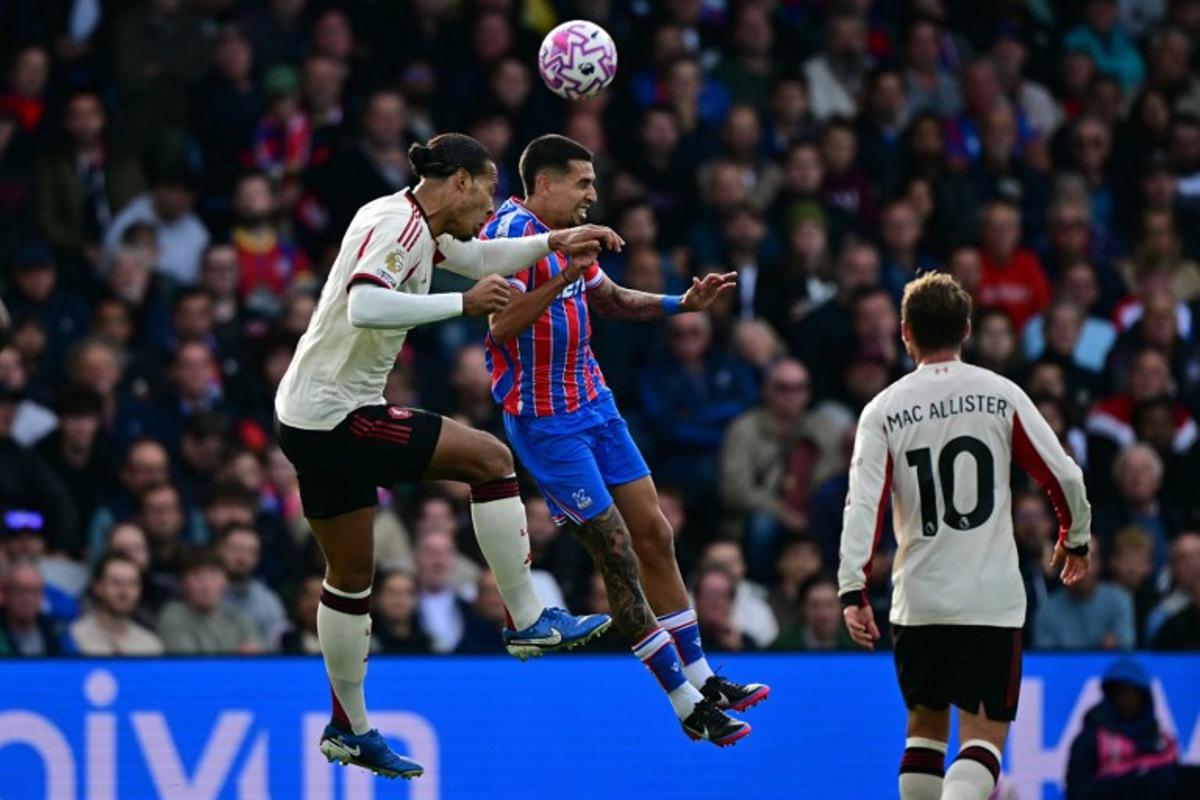 Liverpool's Dutch defender #04 Virgil van Dijk (L) vies with Crystal Palace's Colombian defender #02 Daniel Munoz (C) during the English Premier League football match between Crystal Palace and Liverpool at Selhurst Park in south London on September 27, 2025. Ben STANSALL / AFP