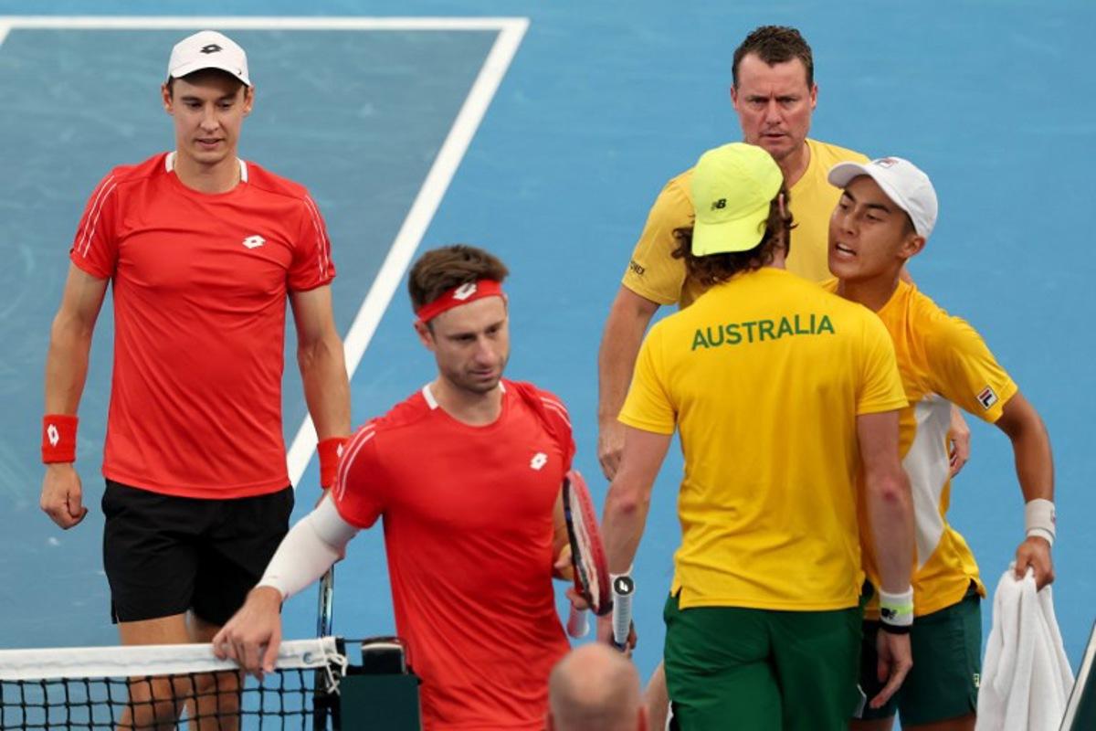 Australia's team captain Lleyton Hewitt (TOP) watches players Rinky Hijikata (R) and Jordan Thompson react after winning the second set against Belgium's Sander Gille and Joran Vliegen (L) during their Davis Cup second-round qualifier doubles tennis match at Ken Rosewall Arena in Sydney on September 14, 2025. DAVID GRAY / AFP
