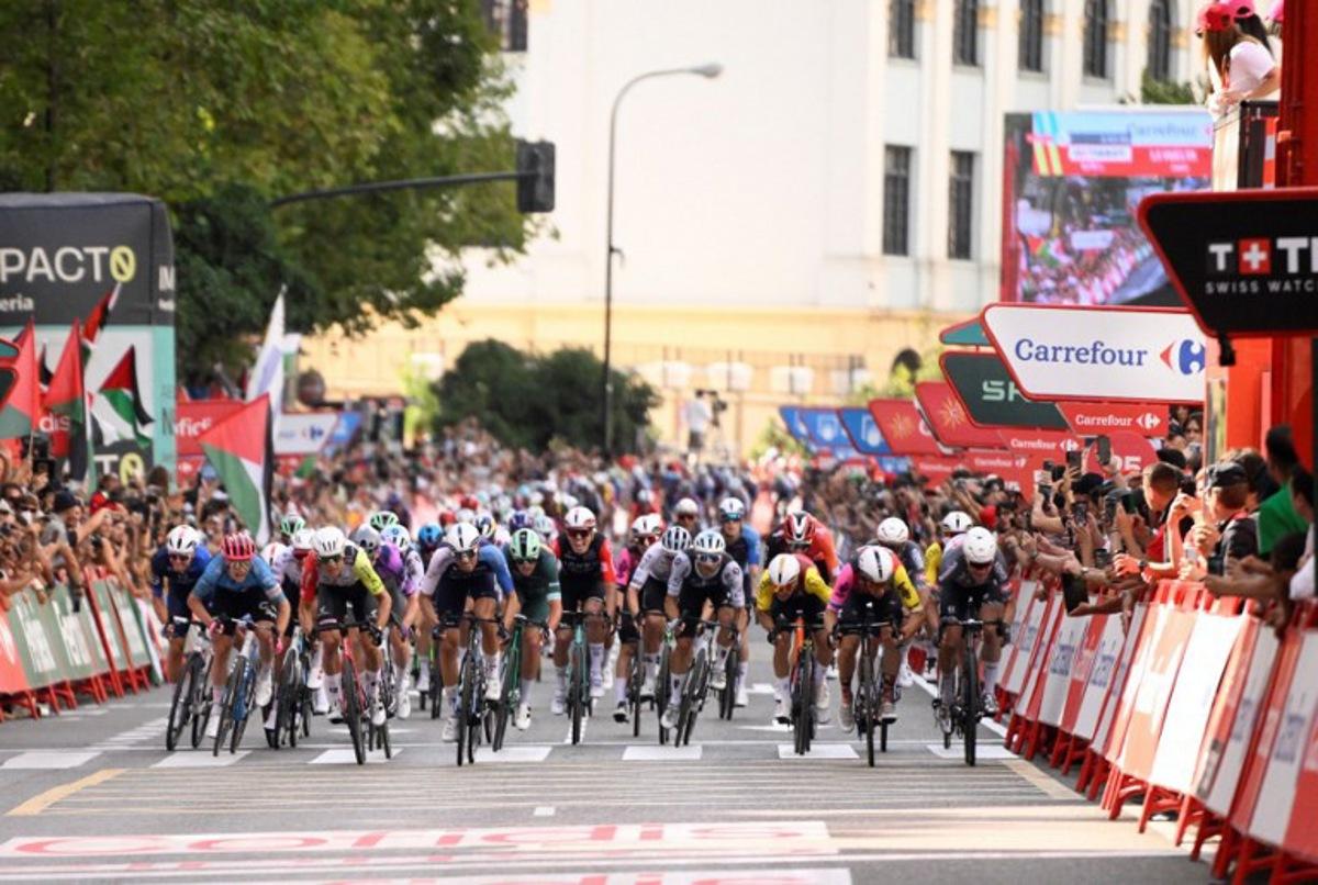 Team Alpecin's Belgian rider Jasper Philipsen (R) competes to cross first the finish line during the 8th stage of the Vuelta a Espana, a 158 km race between Monzon Templario and Zaragoza, on August 30, 2025. Josep LAGO / AFP