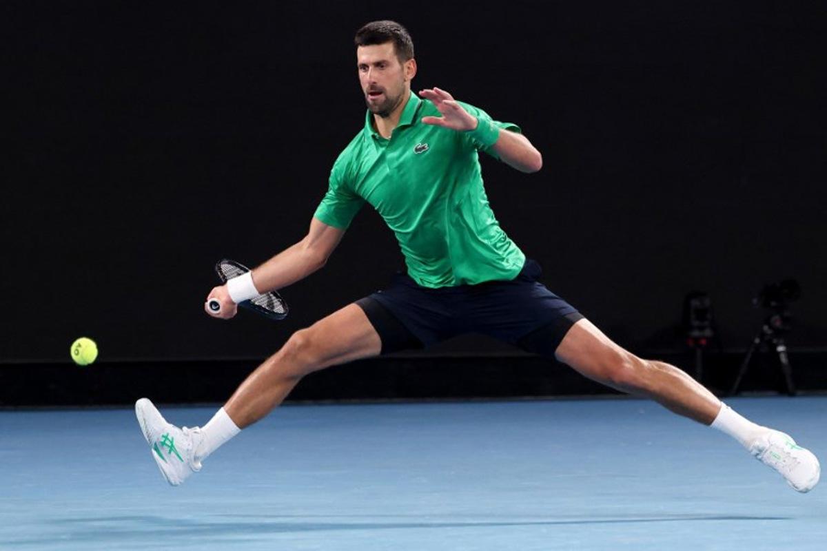Serbia's Novak Djokovic hits a return to Spain's Pedro Martinez during their men's singles match on day two of the Australian Open tennis tournament in Melbourne on January 19, 2026. DAVID GRAY / AFP