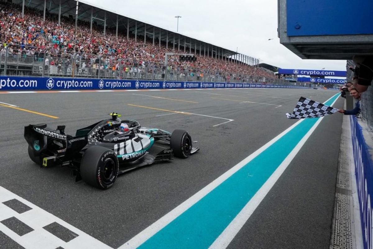 Spanish retired tennis player Rafael Nadal (R) waves the checkered flag for Mercedes' Italian driver Kimi Antonelli during the 2026 Miami Formula One Grand Prix at Miami International Autodrome in Miami Gardens, Florida, on May 3, 2026. Rebecca Blackwell / POOL / AFP