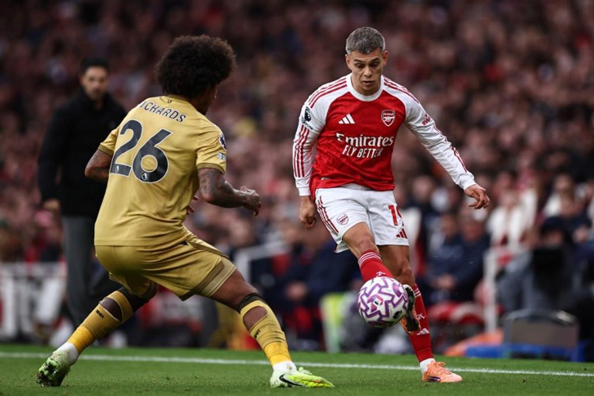 Arsenal's Belgian midfielder #19 Leandro Trossard (R) vies with Crystal Palace's US defender #26 Chris Richards (L) during the English Premier League football match between Arsenal and Crystal Palace at the Emirates Stadium in London on October 26, 2025. HENRY NICHOLLS / AFP