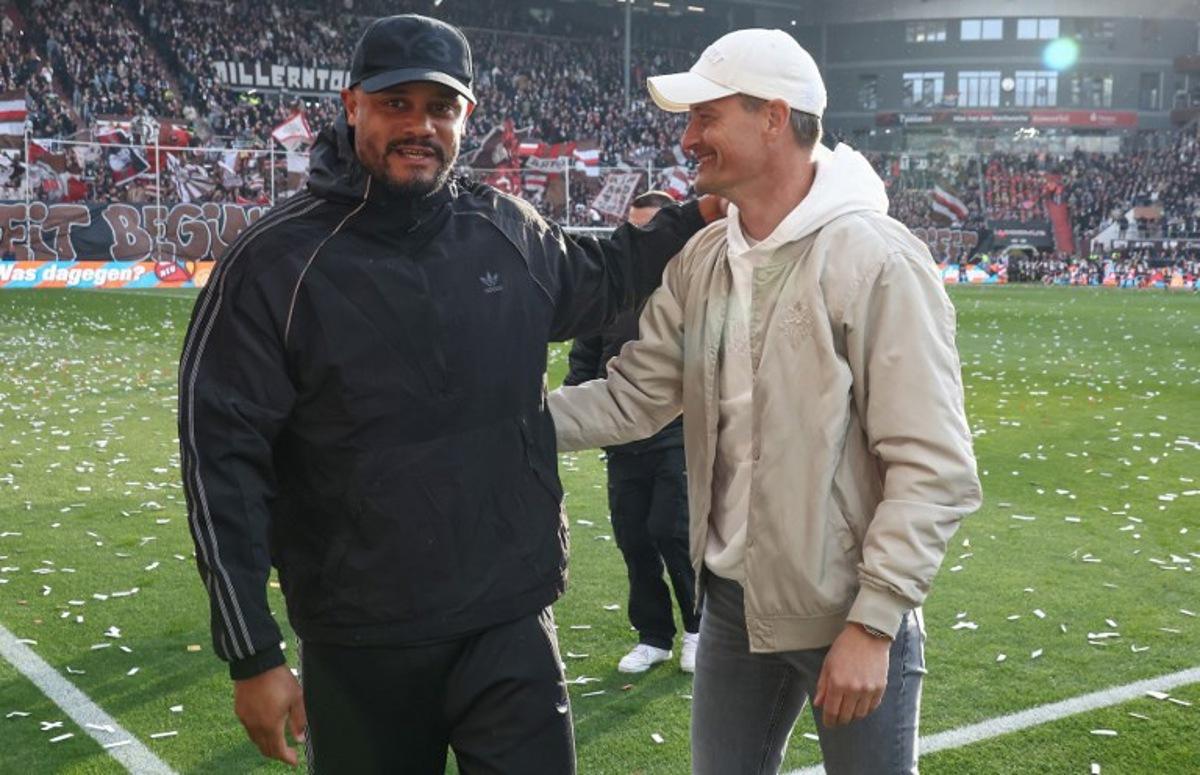 Bayern Munich's Belgian head coach Vincent Kompany (L) and St Pauli's German head coach Alexander Blessin greet each other prior to the German first division Bundesliga football match between FC St Pauli and FC Bayern Munich in Hamburg, northern Germany, on April 11, 2026. Ibo OT / AFP