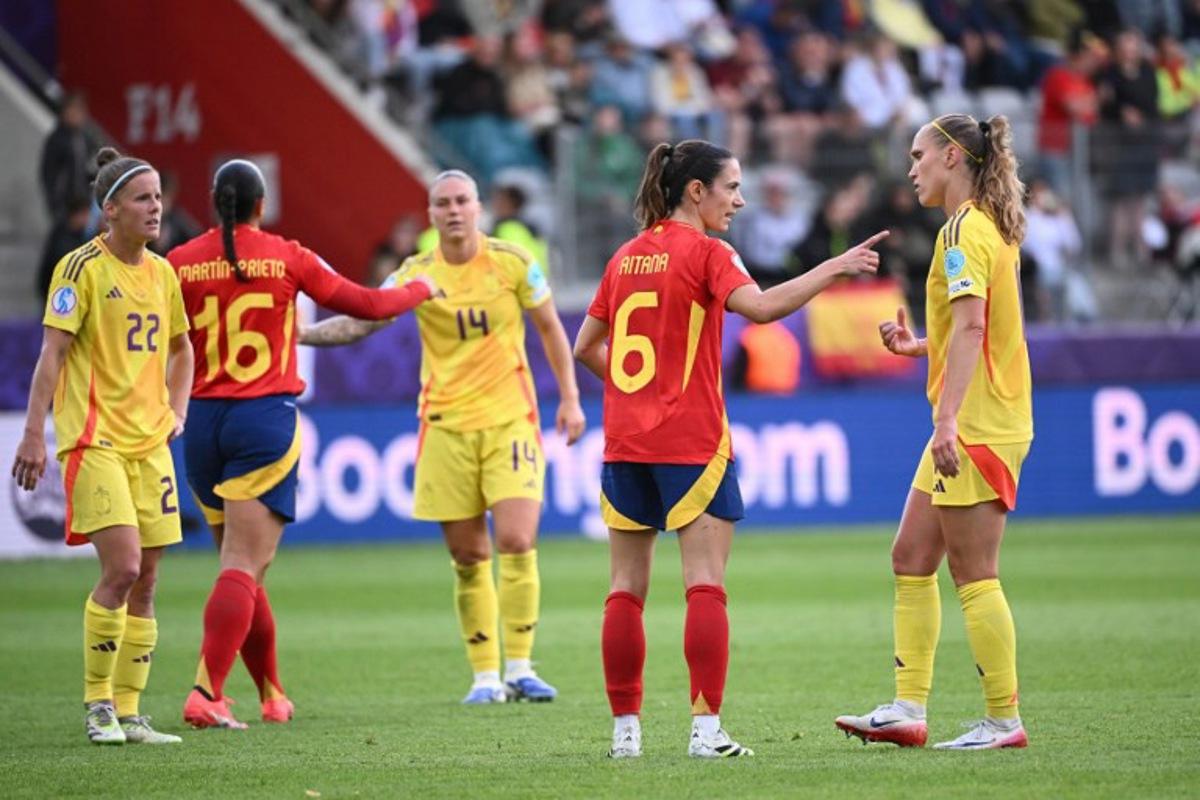 Spain's midfielder #06 Aitana Bonmati (2nd R) and Belgium's defender #11 Janice Cayman (R) react after Spain won the UEFA Women's Euro 2025 Group B football match between Spain and Belgium at the Arena Thun stadium in Thun on July 7, 2025. SEBASTIEN BOZON / AFP