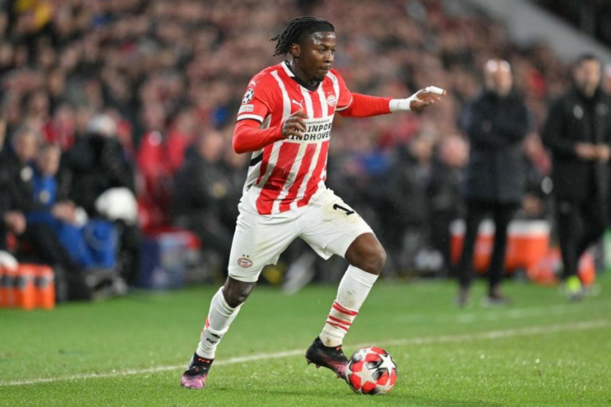 PSV Eindhoven's Belgian forward #11 Johan Bakayoko runs with the ball during the UEFA Champions League, league phase day 8, football match between PSV Eindhoven (NED) and Liverpool FC (ENG) at the the Philips Stadion, in Eindhoven, on January 29, 2025. NICOLAS TUCAT / AFP