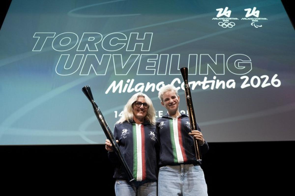 Former cross-country Italian athlete Stefania Belmondo and fencing paralympic champion Bebe Vio (R) pose during the unveiling of the torches for the Milano Cortina 2026 winter olympic and paralympic games in Milan on April 14, 2025. MARCO BERTORELLO / AFP