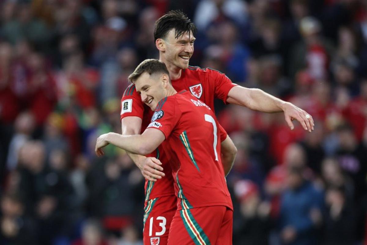Wales' forward #13 Kieffer Moore (L) celebrates with Wales' midfielder #07 David Brooks (R) after scoring their third goal during the 2026 World Cup Group J qualifier football match between Wales and Liechtenstein, at Cardiff City Stadium, in Cardiff, on June 6, 2025. Darren Staples / AFP