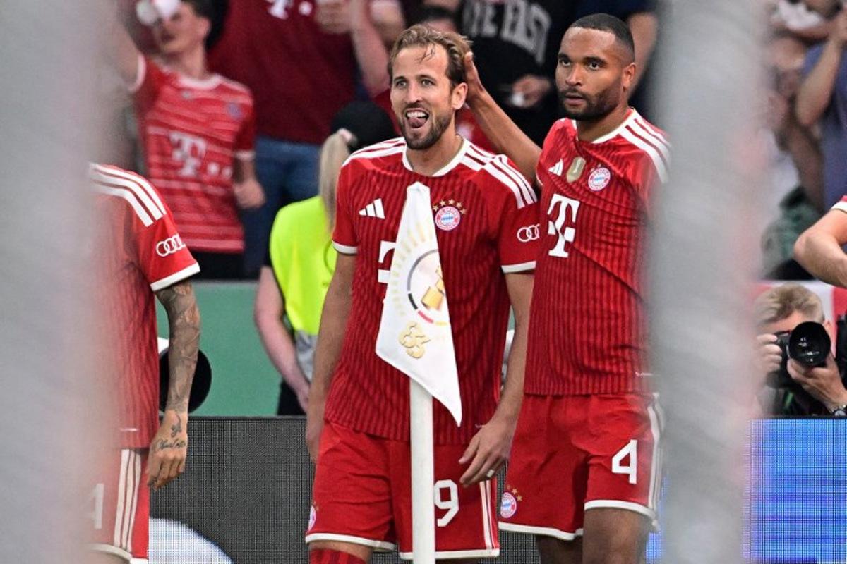 Bayern Munich's English forward #09 Harry Kane celebrates scoring the opening goal with his teammate Bayern Munich's German defender #04 Jonathan Tah during the German Cup (DFB Pokal) final football match FC Bayern Munich v VfB Stuttgart at the Olympic Stadium in Berlin, on May 23, 2026. Tobias SCHWARZ / AFP