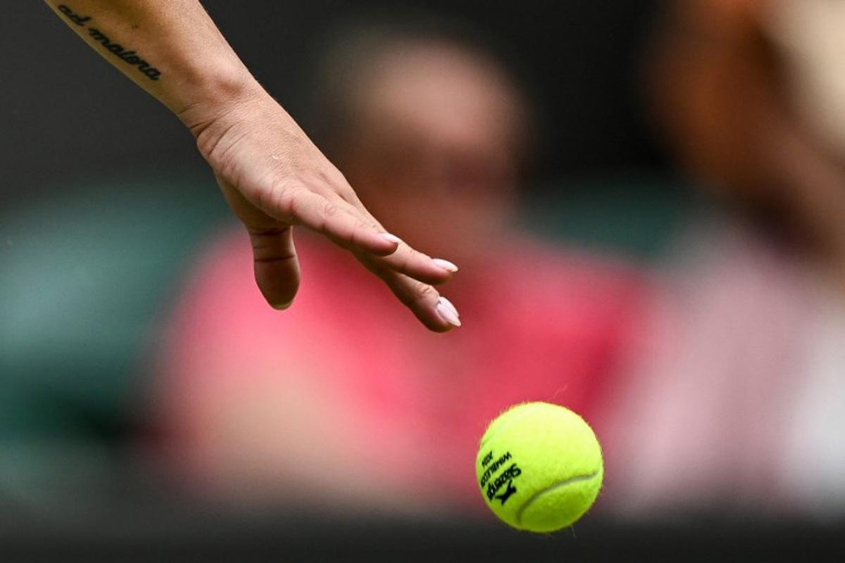 The tatoo of Italy's Martina Trevisan reading "A Maiora" in Latin (which translates as "Towards greater things" in English) is pictured on her arm as she bounces the ball prior to serve against US player Madison Keys during their Women's singles tennis match on the first day of the 2024 Wimbledon Championships at The All England Lawn Tennis and Croquet Club in Wimbledon, southwest London, on July 1, 2024. Ben Stansall / AFP