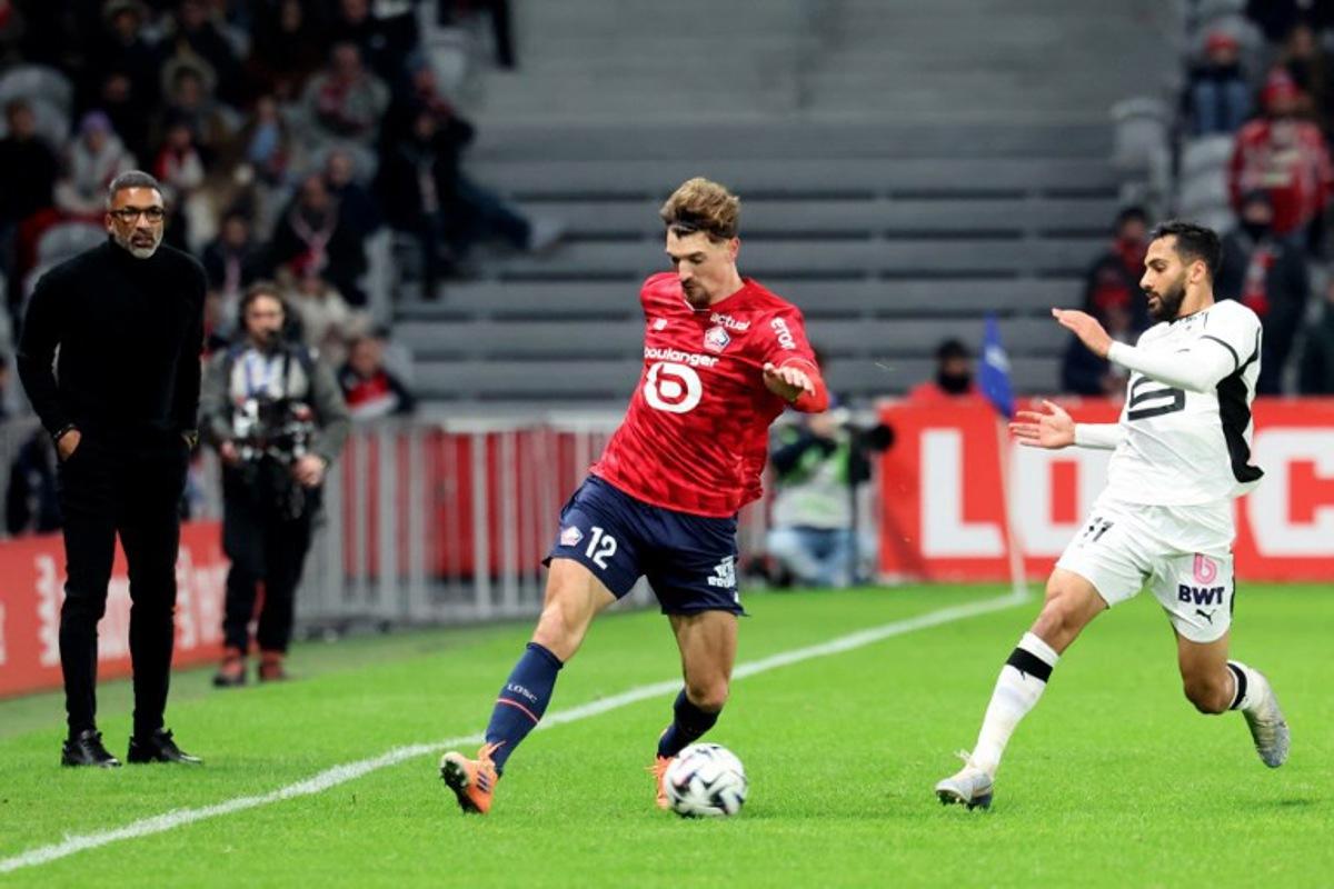 Lille's Belgian defender #12 Thomas Meunier (L) and Rennes' Jordanian forward #11 Mousa Tamari fight for the ball during the French L1 football match between Lille LOSC and Stade Rennais FC at the Stade Pierre-Mauroy in Villeneuve-d'Ascq, northern France, on January 3, 2026. Francois LO PRESTI / AFP
