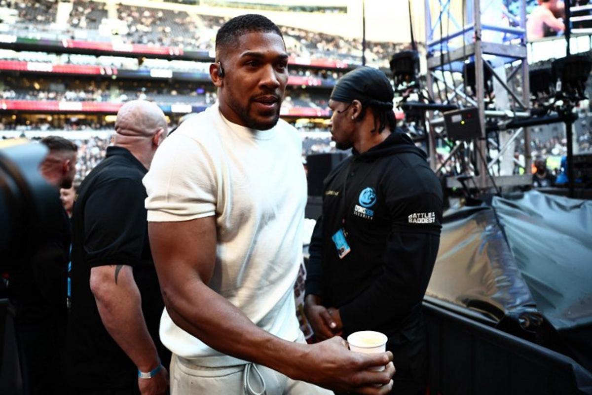 British boxer Anthony Joshua is seen ringside ahead of the heavyweight fight between Britain's Tyson Fury and Russia's Arslanbek Makhmudov at the Tottenham Hotspur stadium in London on April 11, 2026. Henry NICHOLLS / AFP