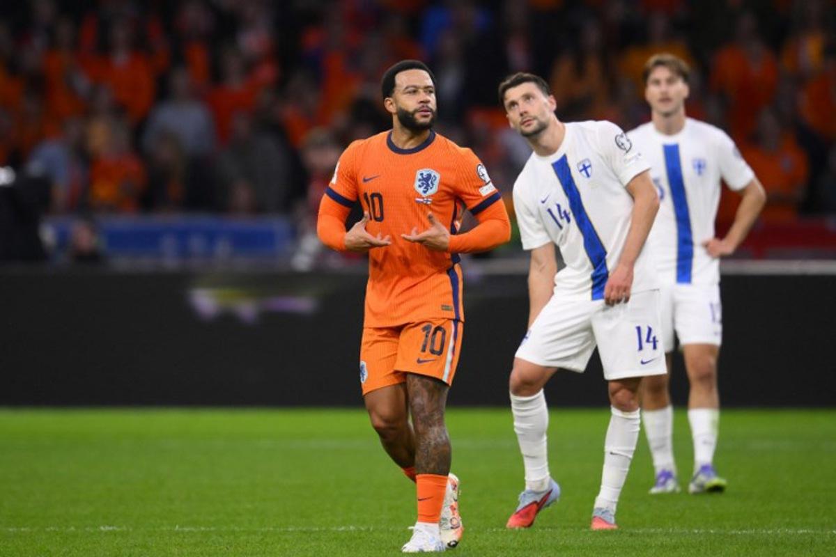 Netherlands' forward #10 Memphis Depay (L) celebrates scoring his team's third goal from the penalty spot during the FIFA World Cup 2026 Group G qualification football match between Netherlands and Finland, at the Johan Cruyff Arena in Amsterdam, on October 12, 2025. JOHN THYS / AFP