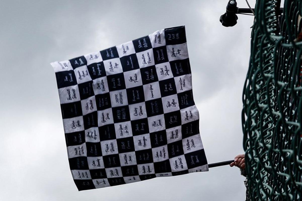 A race marshal waves the checkered flag at the end of the Formula One Belgian Grand Prix at the Spa-Francorchamps Circuit in Spa on July 30, 2023. SIMON WOHLFAHRT / POOL / AFP