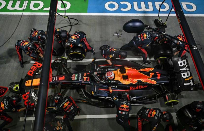 Mechanics work on the car of Red Bull Racing's Dutch driver Max Verstappen in the pit lane during the Singapore Formula One Grand Prix night race at the Marina Bay Street Circuit in Singapore on September 17, 2023. MOHD RASFAN / AFP