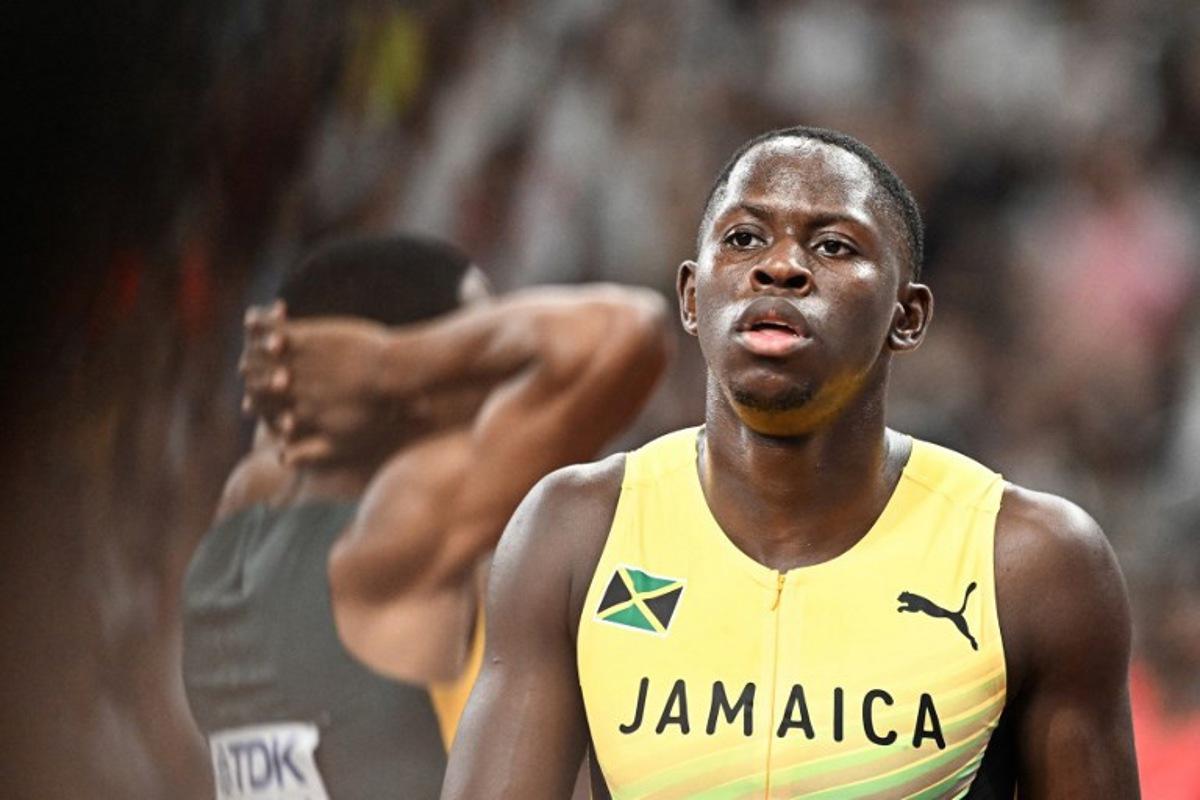Jamaica's athlete Oblique Seville (R) reacts after competing in the men's 100m semi-final during the World Athletics Championships in Tokyo on September 14, 2025. Jewel SAMAD / AFP
