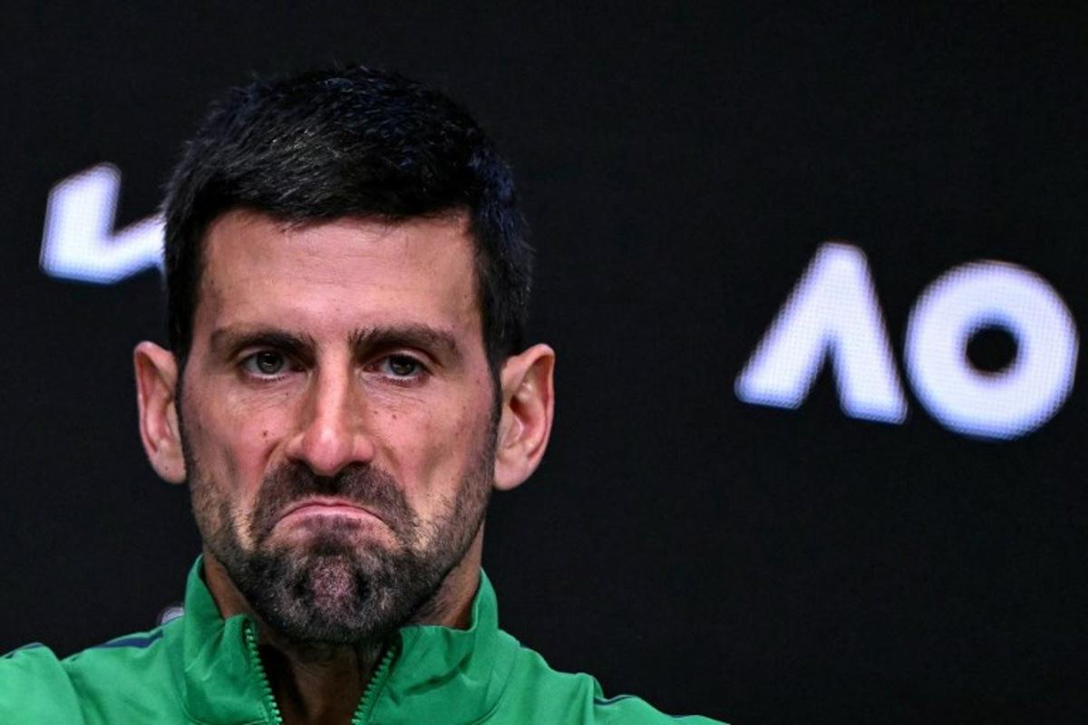 Serbia's Novak Djokovic reacts during a press conference after his defeat against Spain's Carlos Alcaraz in their men's singles final match on day fifteen of the Australian Open tennis tournament in Melbourne on February 1, 2026. WILLIAM WEST / AFP