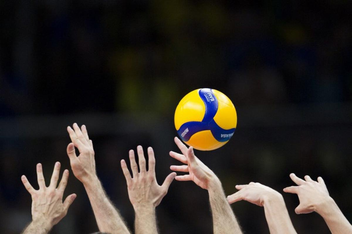 Players jump for the ball during the pool A volleyball Olympic qualifier match between Brazil and Italy, in Rio de Janeiro, Brazil, on October 8, 2023. DANIEL RAMALHO / AFP