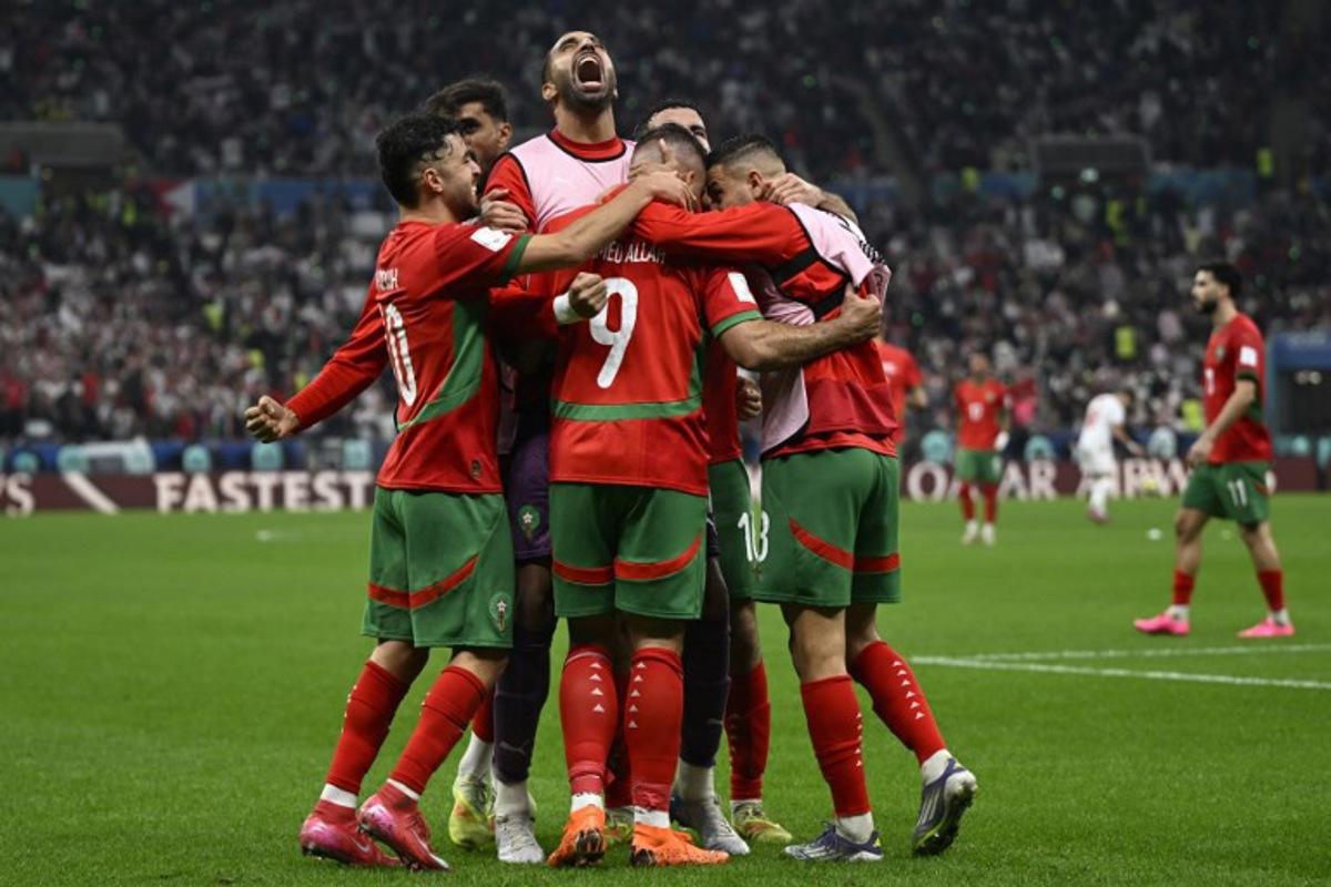 Morocco's forward #9 Abderrazzaq Hamed Allah celebrates with his teammates after scoring his team's seccond goal during the FIFA Arab Cup 2025 final football match between Jordan and Morocco at the Lusail Stadium Stadium, in Lusail on December 18, 2025. Mahmud HAMS / AFP