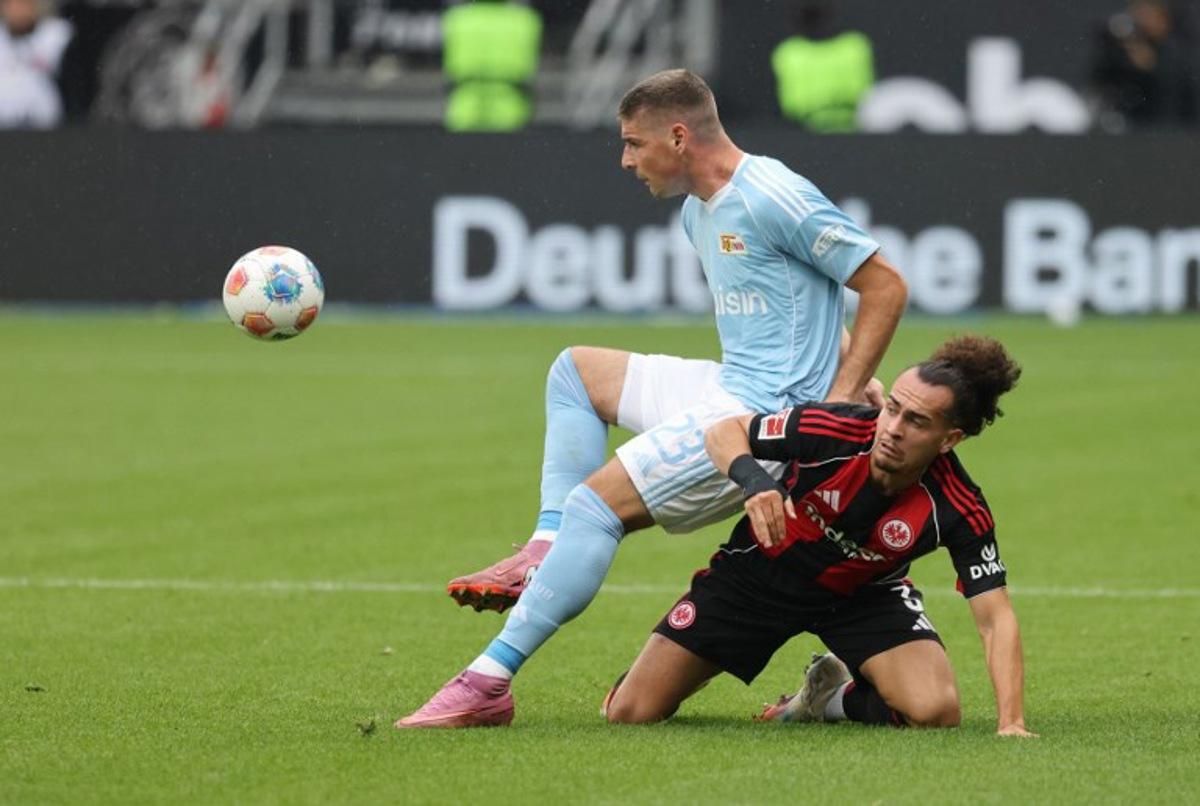 Union Berlin's Serbian forward #23 Andrej Ilic (L) and Frankfurt's Belgian defender #03 Arthur Theate vie for the ball during the German first division Bundesliga football match between Eintracht Frankfurt and 1 FC Union Berlin in Frankfurt am Main, western Germany on September 21, 2025. Daniel ROLAND / AFP