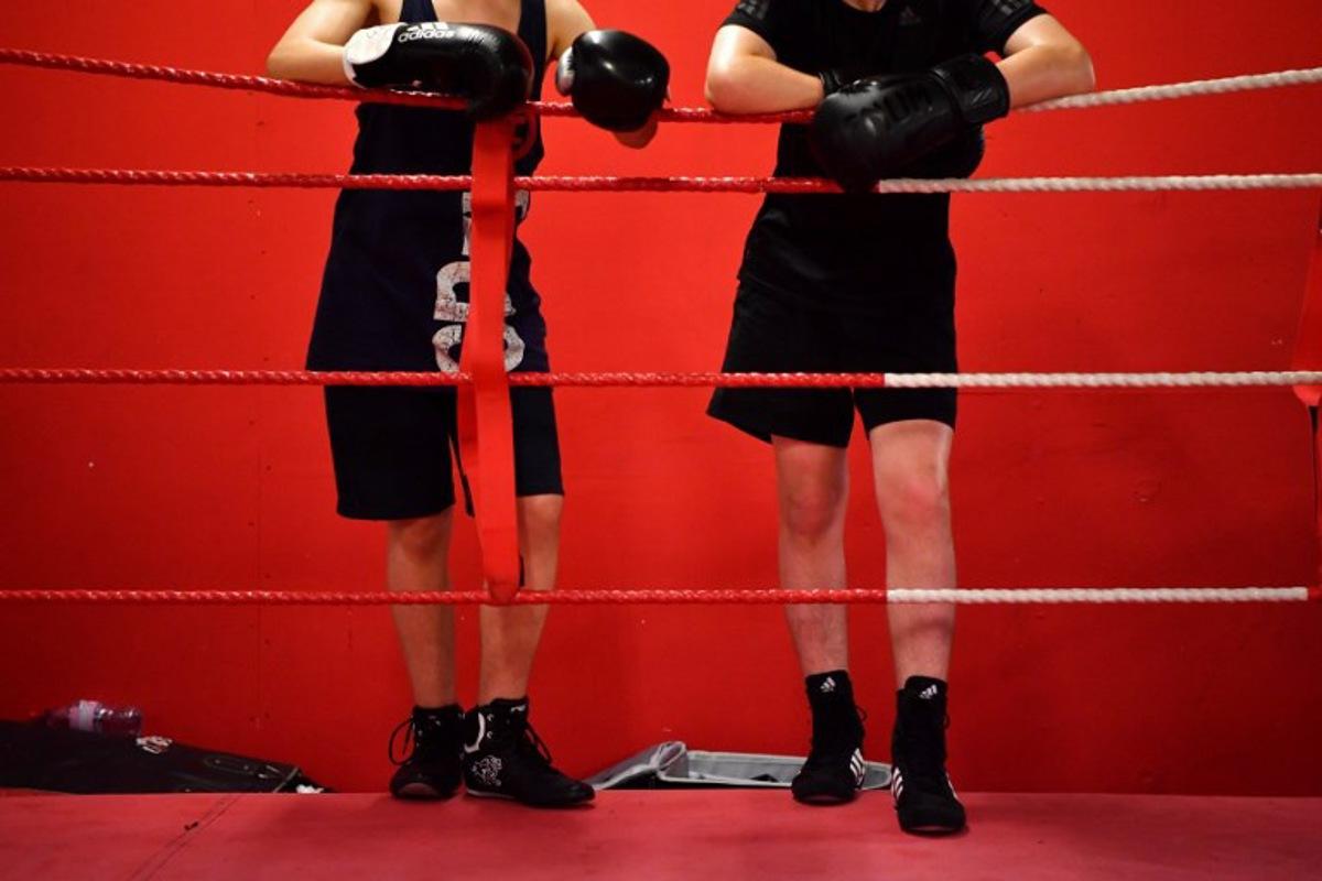 Young boxers take a break during a training session at the Box Clever Sports club in Ladbroke Grove, west London on June 8, 2018. The iconic Dale Youth boxing club has picked itself off the canvas since being gutted in the Grenfell Tower fire that killed 71 people and become an unlikely sanctuary for those affected. BEN STANSALL / AFP