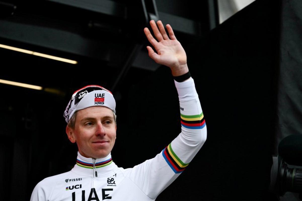 UAE Team Emirates's Slovenian Tadej Pogacar waves as he celebrates on the podium after winning the 20th one-day classic 'Strade Bianche' (White Roads) men's cycling race between Siena and Siena in Tuscany on March 7, 2026. Marco BERTORELLO / AFP