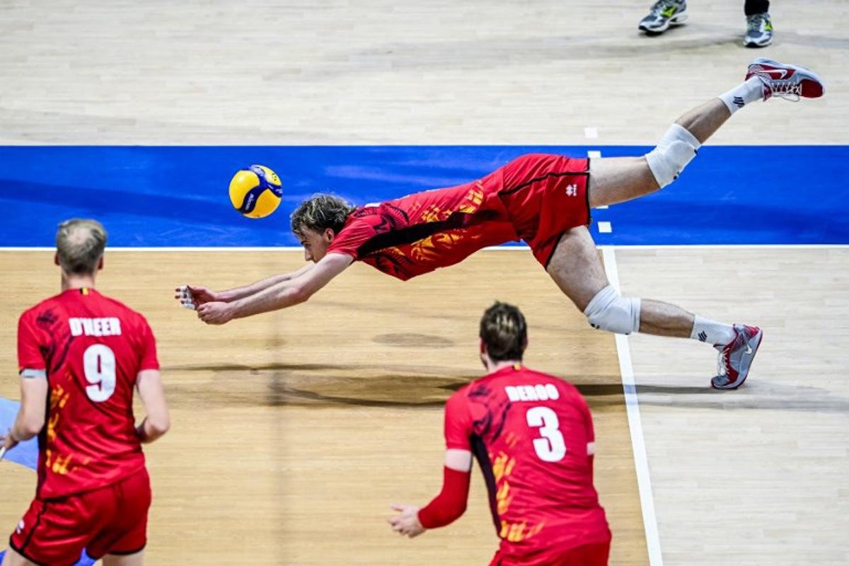 Belgium's Ferre Reggers dives for the ball against Italy during the 2025 Men's Volleyball World Championship at the Araneta Coliseum in Quezon City on September 16, 2025. SHERWIN VARDELEON / AFP