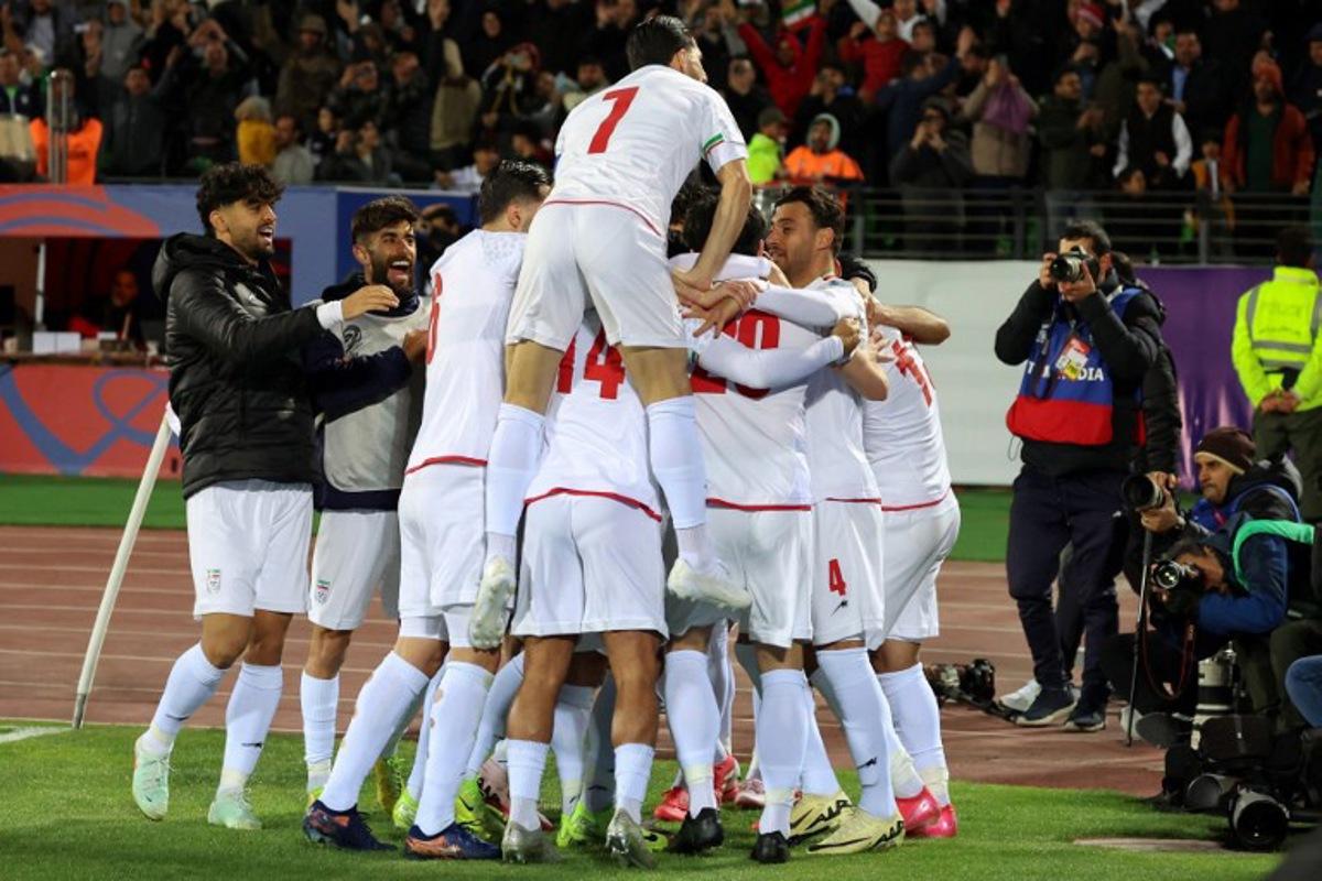 Iran's players celebrate after scoring during the FIFA World Cup 2026 Asia zone qualifiers group A football match between Iran and Uzbekistan, on March 25, 2025 in Tehran. AFP