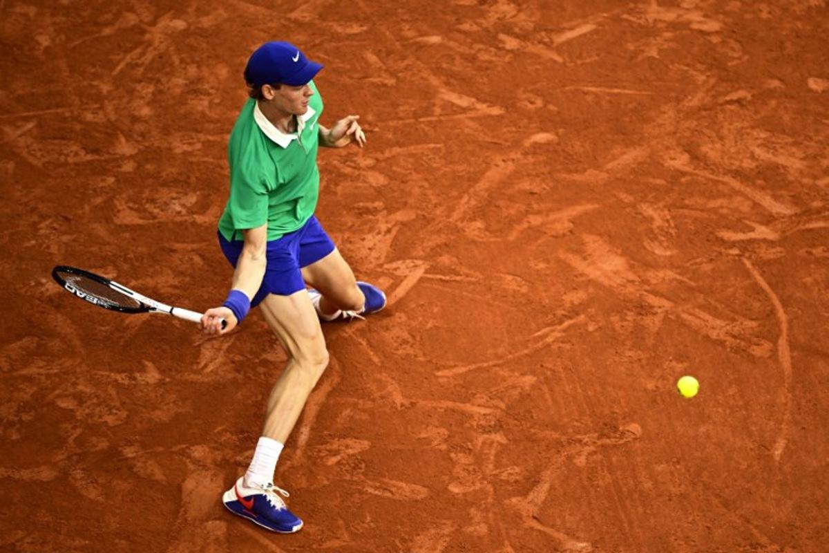 Italy's Jannik Sinner plays a forehand return to Serbia's Novak Djokovic during their men's singles semi-final match on day 13 of the French Open tennis tournament on Court Philippe-Chatrier at the Roland-Garros Complex in Paris on June 6, 2025. JULIEN DE ROSA / AFP